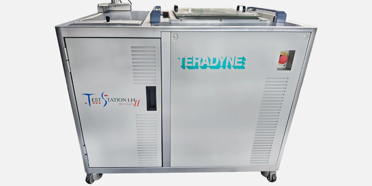 TSLH GALLERY IMAGE EXAMPLE 2: #2 Teradyne TestStation LH test system featuring top‑mounted fixture plate, connected power and pneumatic cables, and a vertical sensor arm used for automated test operations.