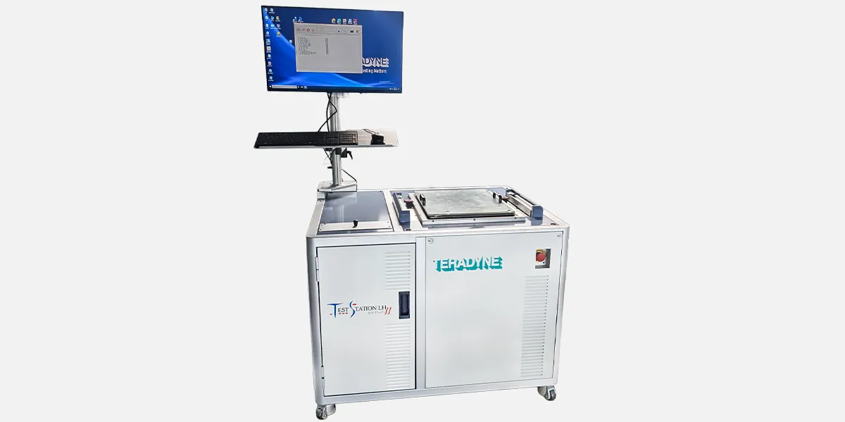 TSLH GALLERY IMAGE EXAMPLE 2: #4 Teradyne TestStation LH test system with integrated operator console, monitor displaying test interface, keyboard tray, and top‑mounted fixture area.